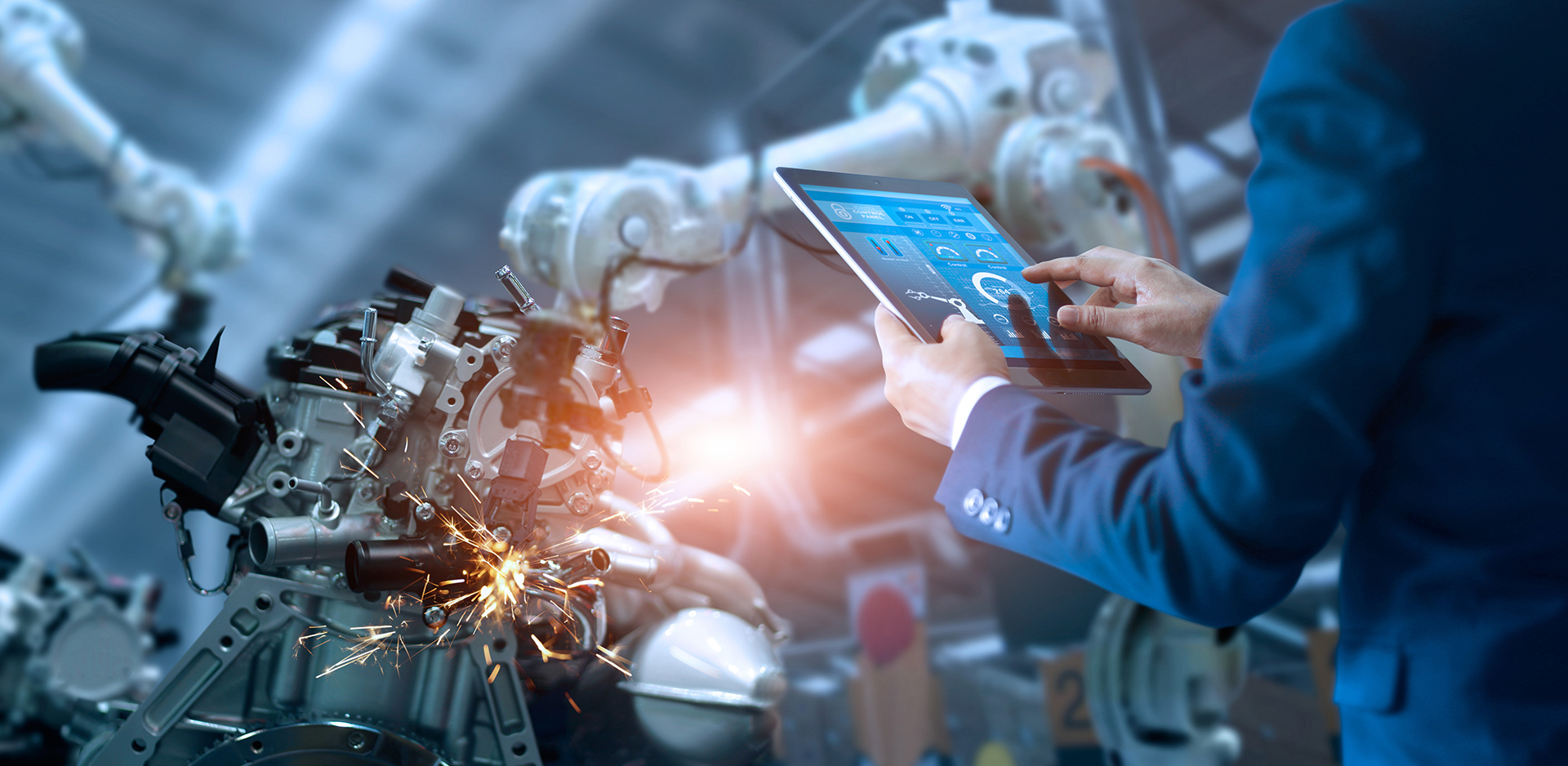 Technician using a tablet to manage industrial machinery processes integrated with Syspro ERP.